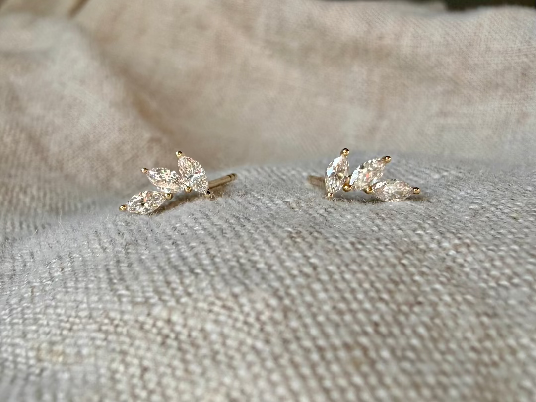 AUREN AND CO marquise diamone earrings on beige background